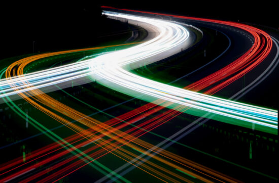 Night road lights. Lights of moving cars at night. long exposure red, blue, green, orange.