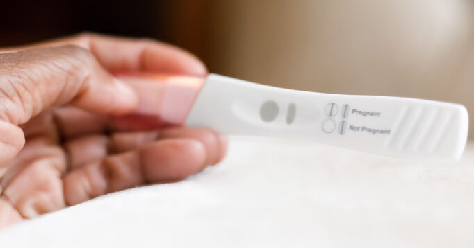 Reading a home pregnancy test.