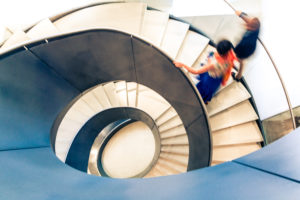 people walking on curved staircase to represent consideration of appeals cases compelling discovery orders