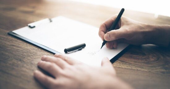 Hands-pen-and-clipboard-GettyImages-1042513460_1200x630