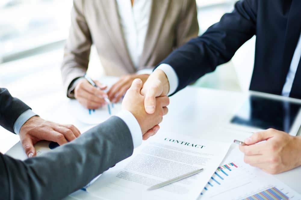 Need for Insurance in Joint Ventures Commercial and Business Law handshake close up executives min - Need for Insurance in Joint Ventures in Commercial and Business Law