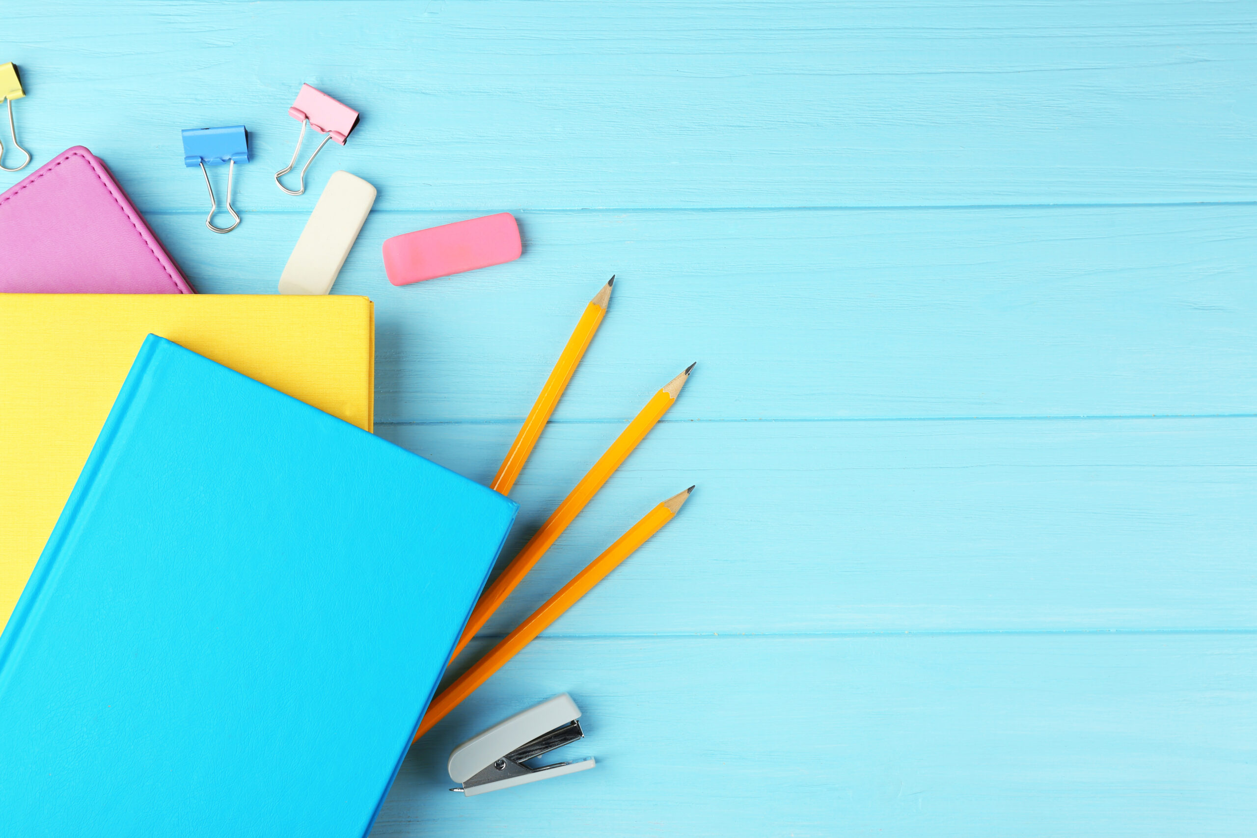 Colorful,Notebooks,And,Office,Supplies,On,Wooden,Background