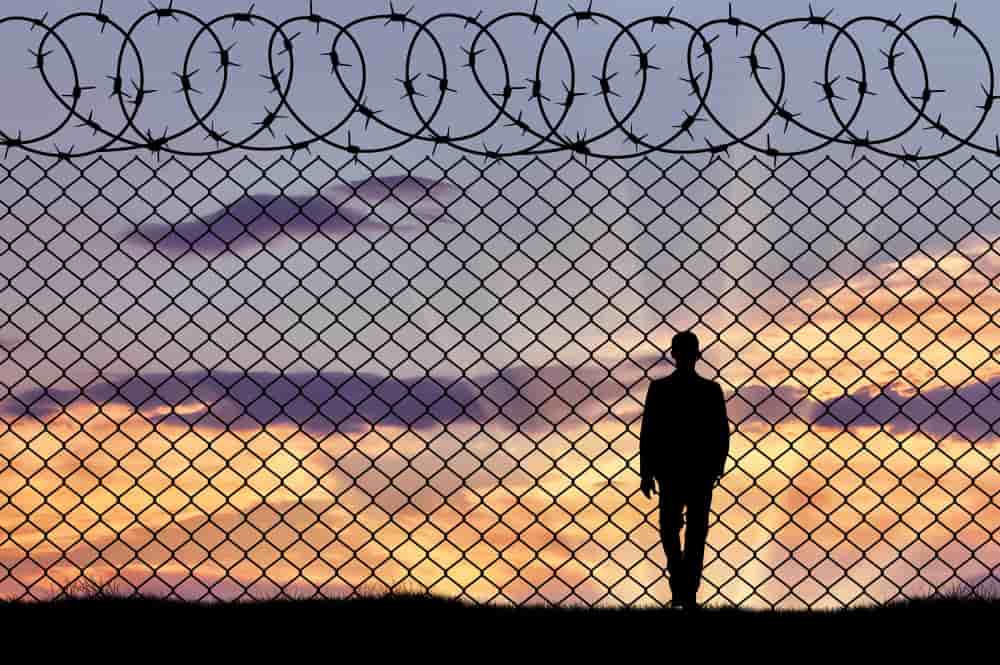 concept refugee silhouette refugee near border fence sunset min 1 - Refugee Deportation in the EU in General