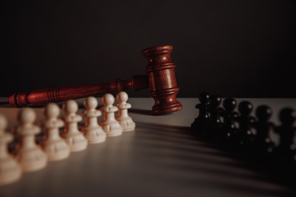 sue someone for legal disputes General A wooden hammer and chess showing issues to sue someone for legal disputes