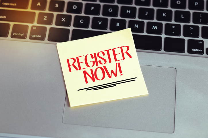 Register Now! written on Sticky Note on Laptop Keyboard
