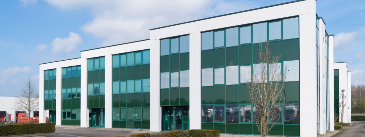 exterior of a modern green office building in the Netherlands-Shutterstock_1673437588