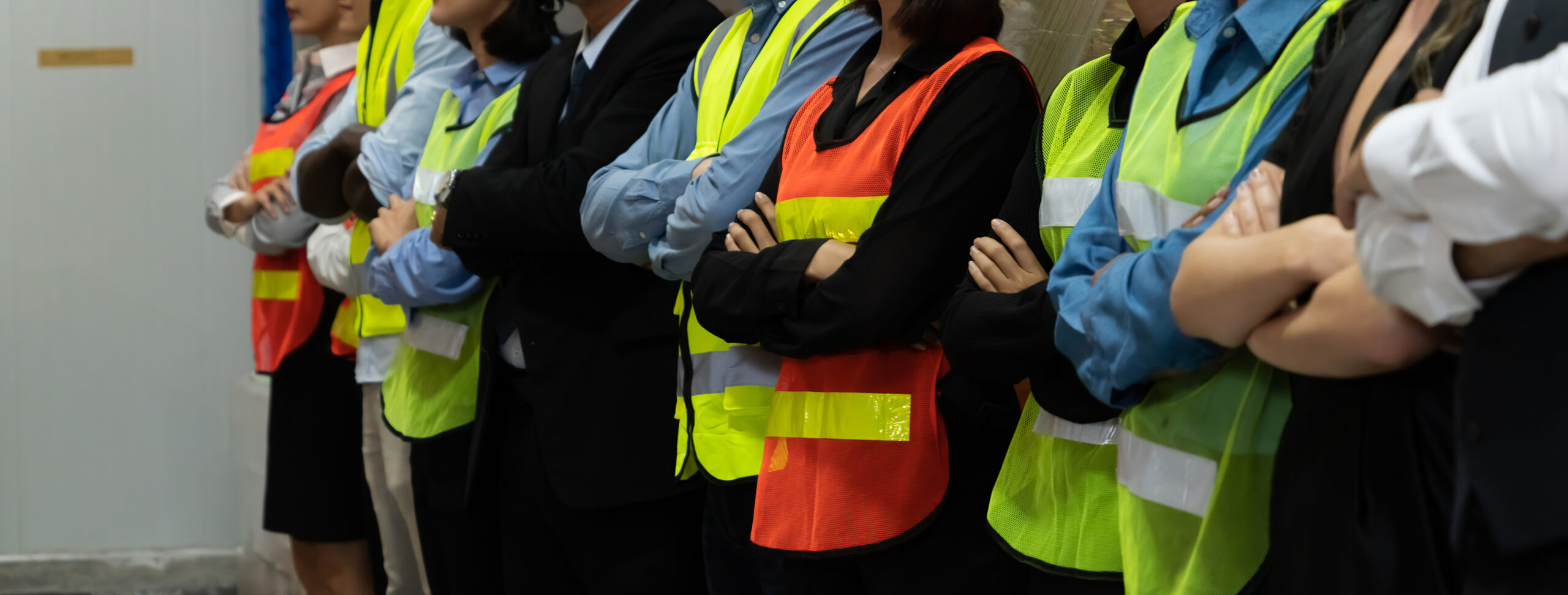 Large group of factory worker standing together in warehouse or storehouse