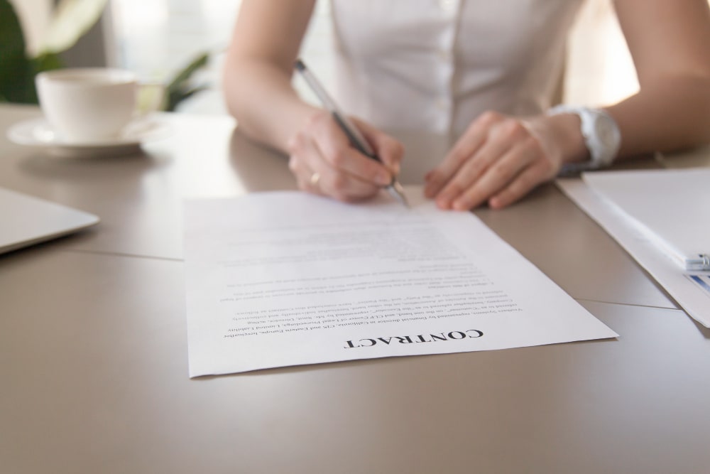 Force Majeure Clause General A business women signing a contract after seeking amendment for Force Majeure Clause