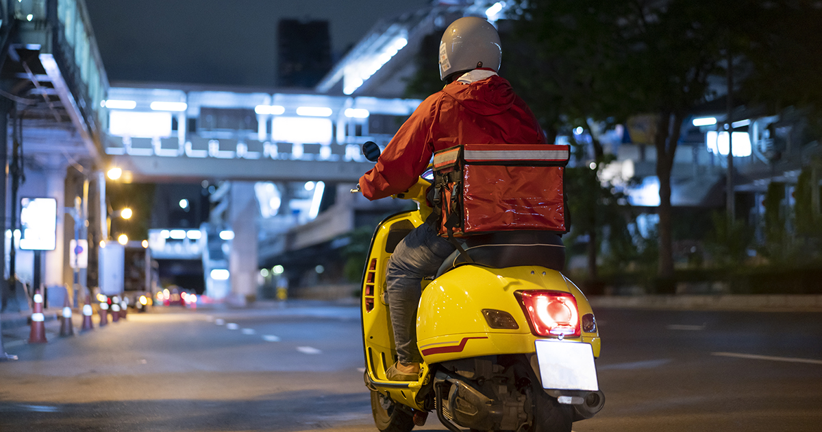 delivery man driving a scooter