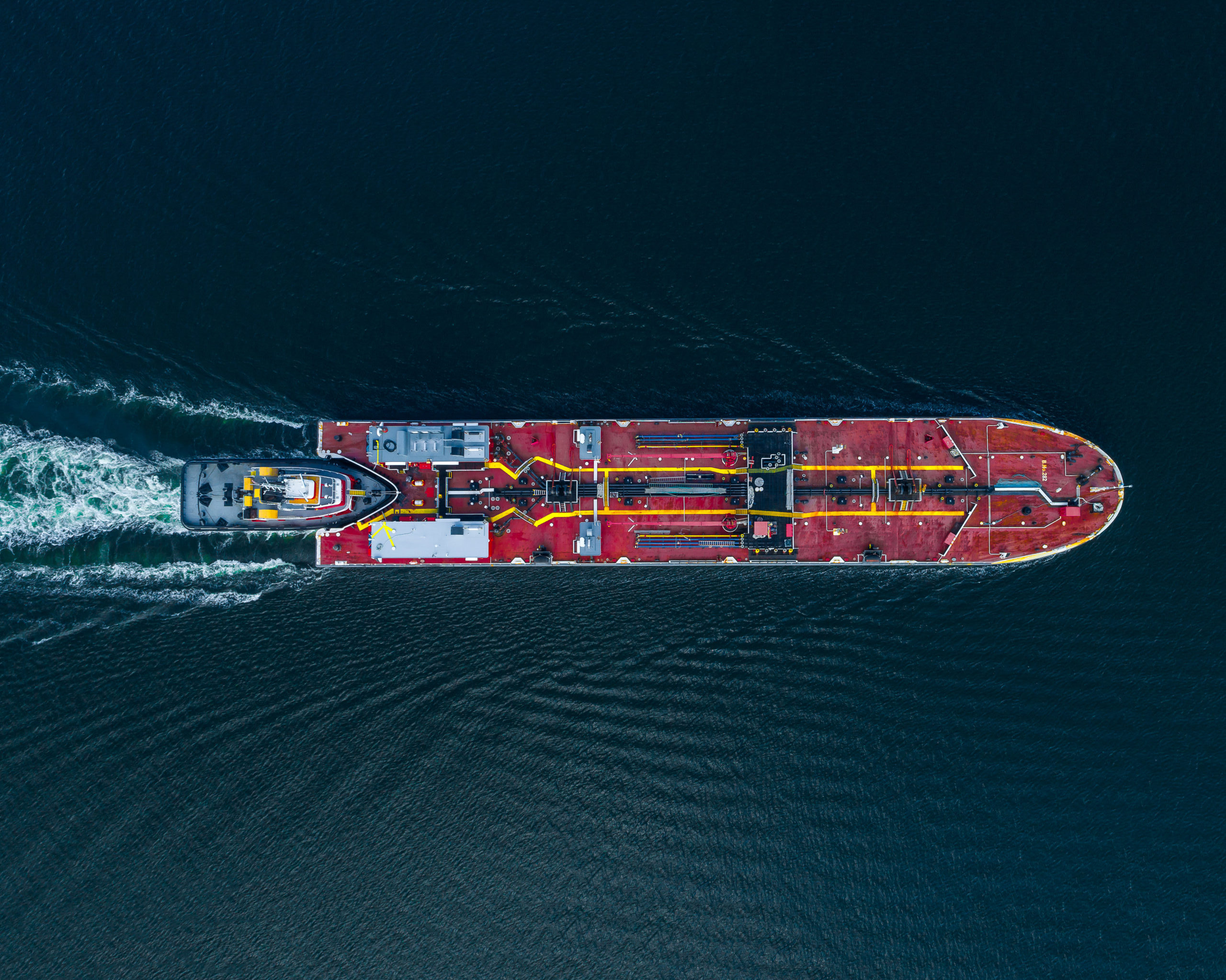 Aerial,View,Of,A,Tug,Boat,Pushing,A,Barge,Carrying