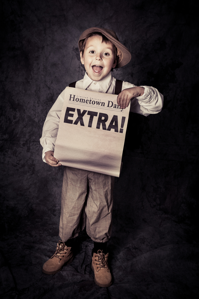 Happy,Young,Newsboy,Holds,Out,A,Newspaper,With,Copy,Space