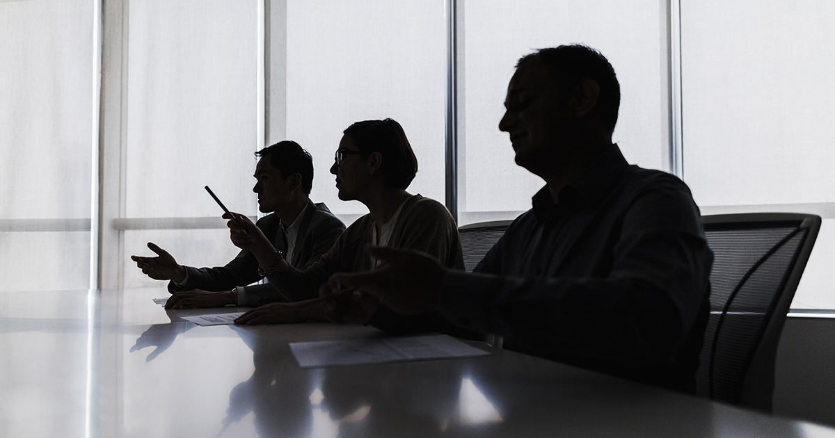 Silhouette of business people negotiating at meeting table