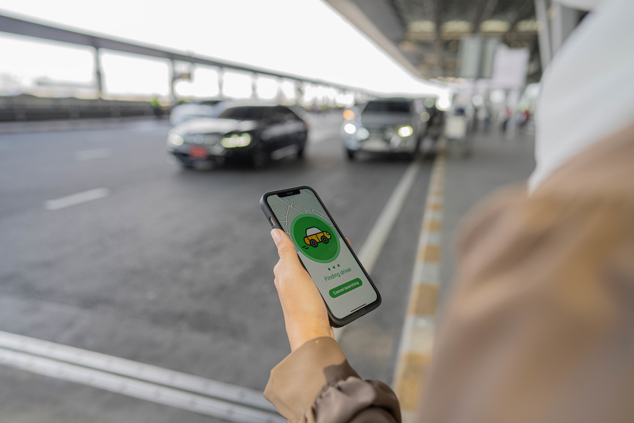Muslim business waiting for uber taxi at outside airport.