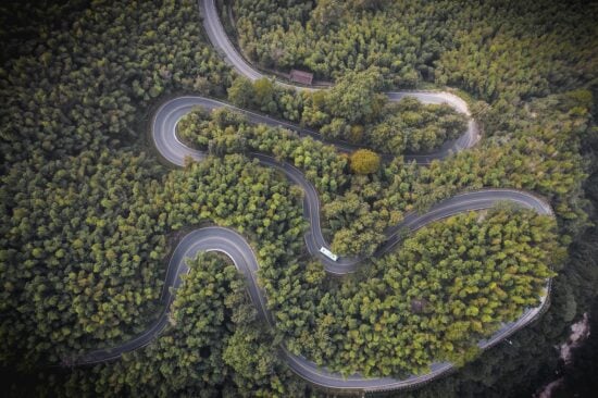 A winding road through the forest on Mount Jiuhua, Anhui Province China.
