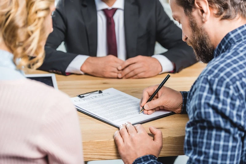 couple signing a contract together