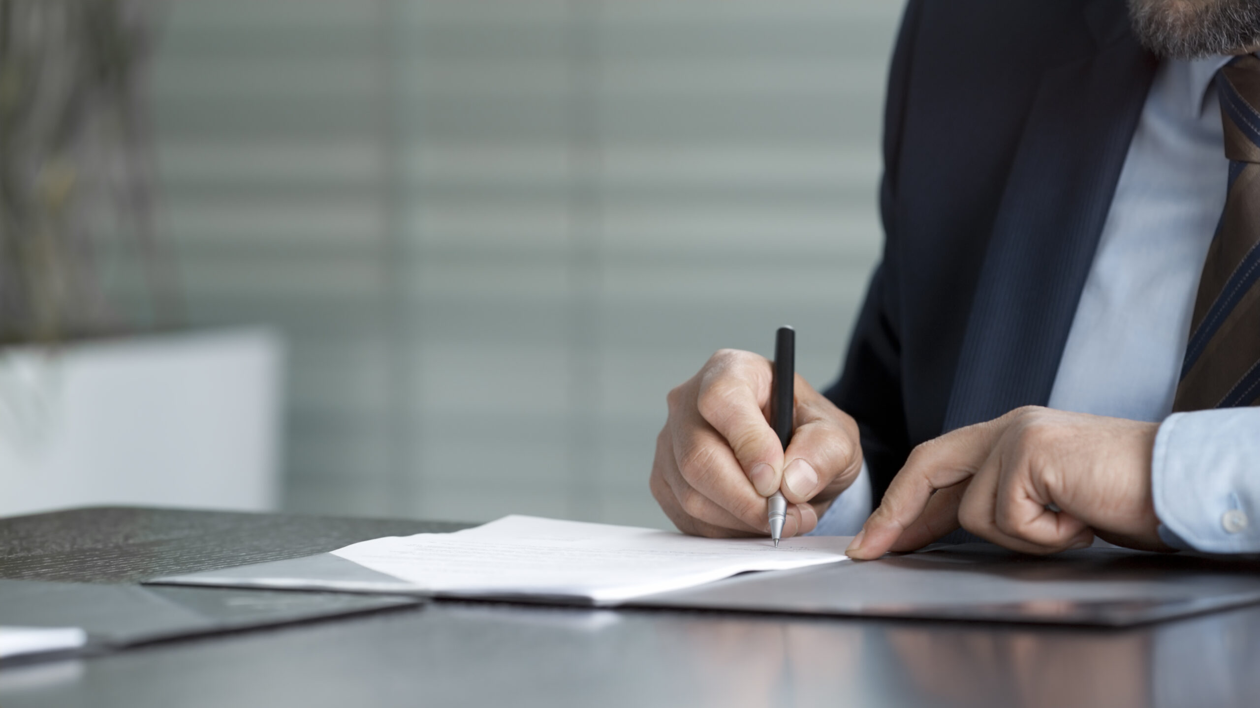 Hands of businessman signing contract