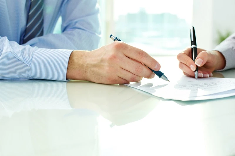 people discuss and sign a contract