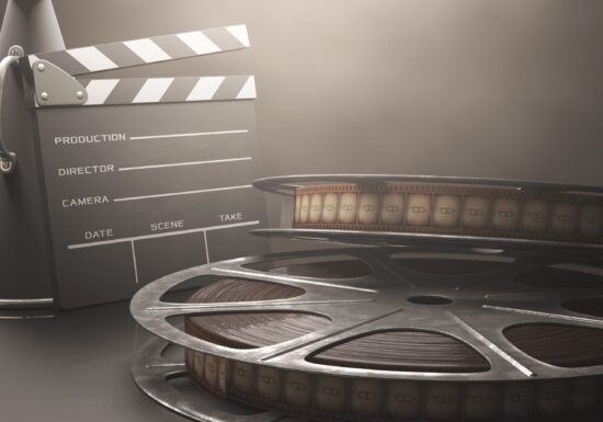 Clapperboard,With,Rolls,Of,Film,In,The,Retro,Concept,Cinema.