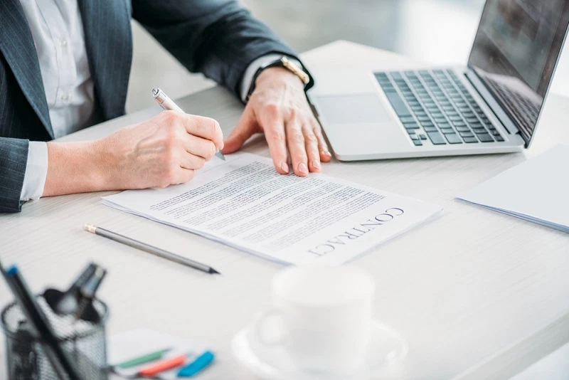 signing a contract at a desk