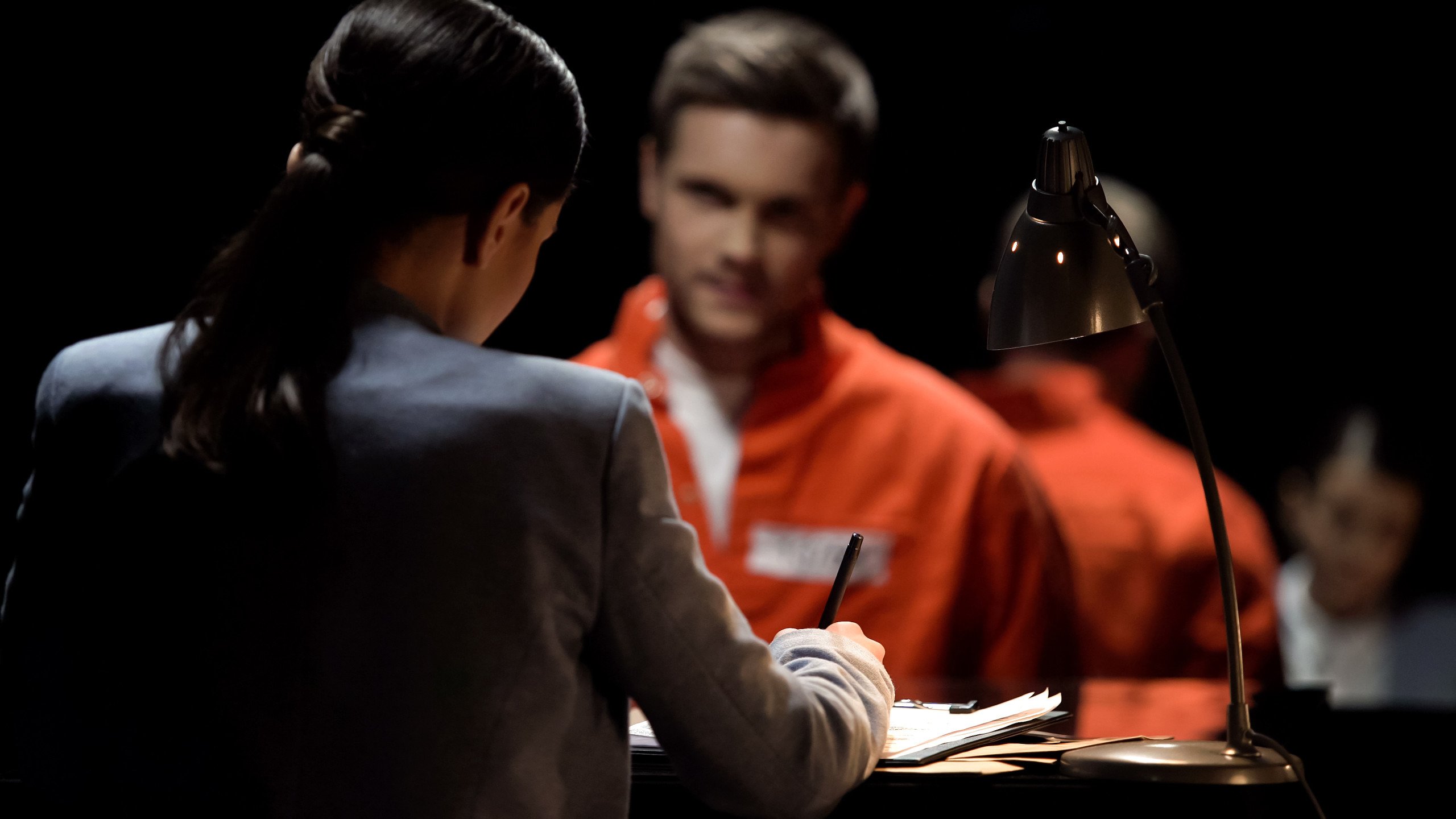 Female defense attorney writing accused prisoners statements for DUI Checkpoint Sign