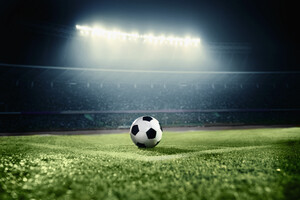 Football in the middle of a stadium.