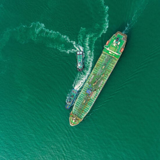 Aerial top view Oil ship tanker and tugboat for transportation oil from refinery on the sea.