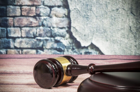 Wooden gavel on a vintage wall background