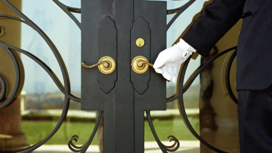 Hotel attendant opening door (mid section)