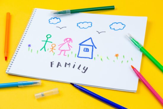 Home, love, family, still life concept. felt-tip pen lying on a paper with children's drawing family. Selective focus, copy space background