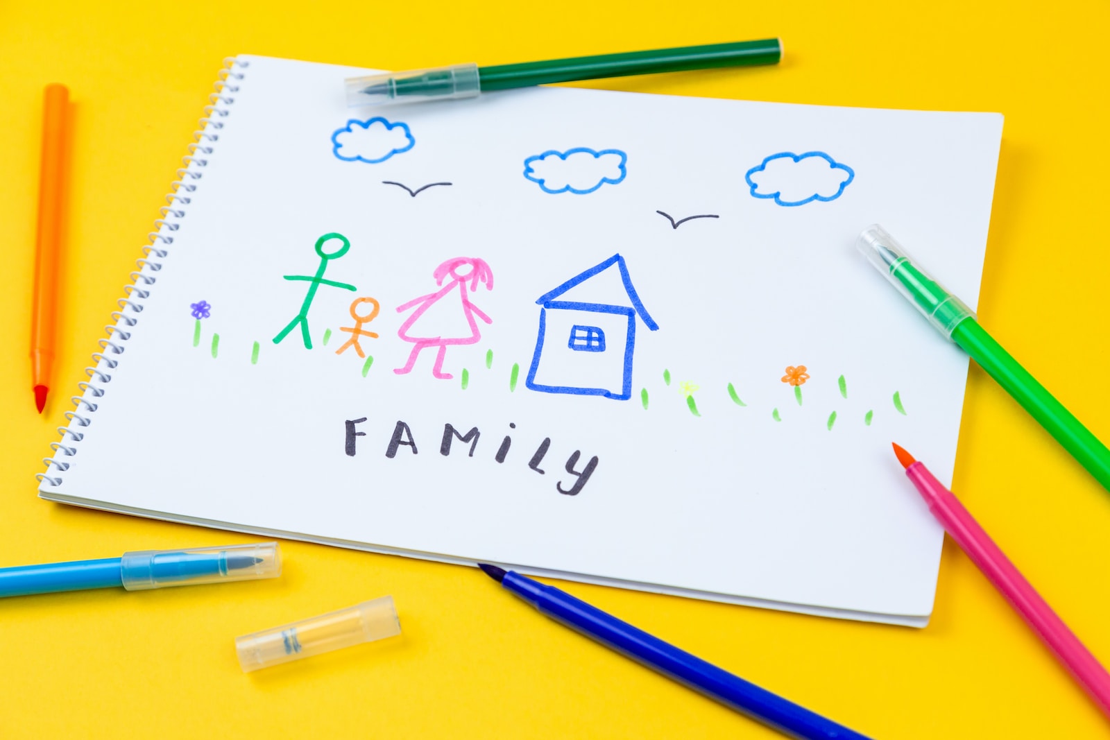 Home, love, family, still life concept. felt-tip pen lying on a paper with children's drawing family. Selective focus, copy space background