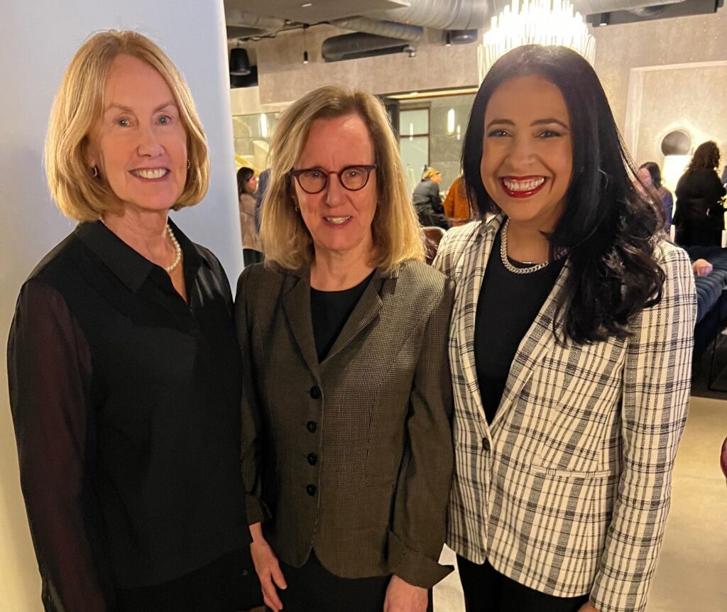 Photo of three professional women posing at an event