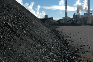 This is a mountain of coal about to be burned by the coal power plant in the background. It's a "clean coal" plant in midwestern America, shot on a cold morning to accentuate the steam plumes.
