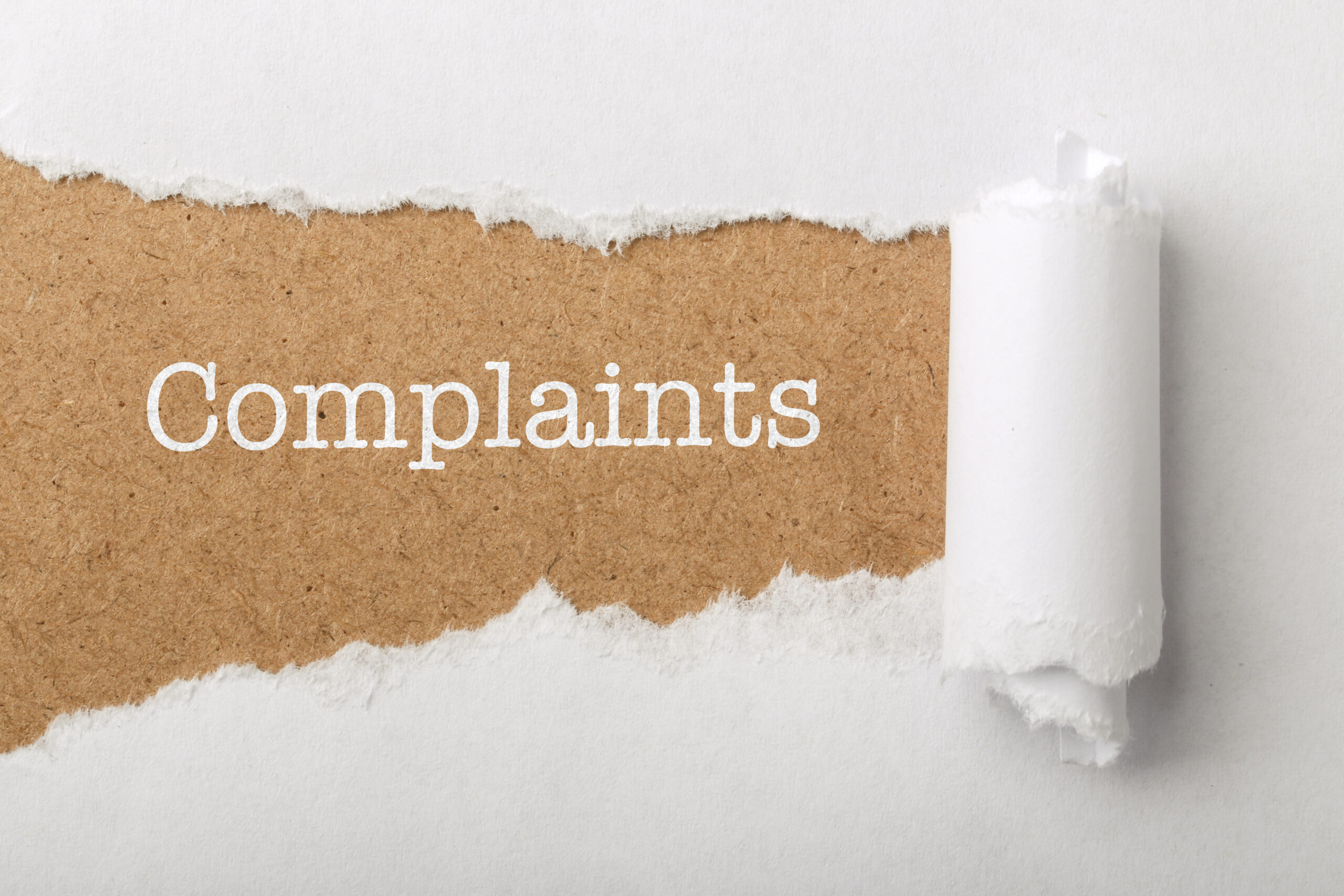 Paper,Tear,Background,With,Word,Complaints.