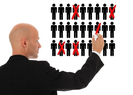 Businessman cutting back jobs
