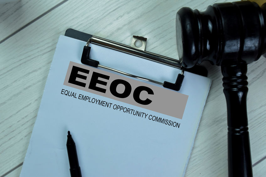 Concept of EEOC - Equal Empoyment Opportunity Commission write on paperwork isolated on Wooden Table.