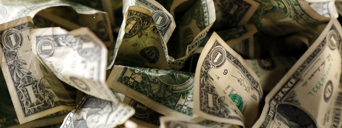 close up wrinkled American one dollar bills pile-Shutterstock_1434855290