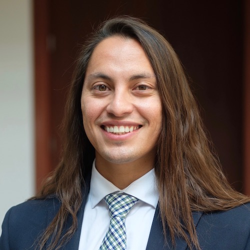 "headshot of long-haired man"