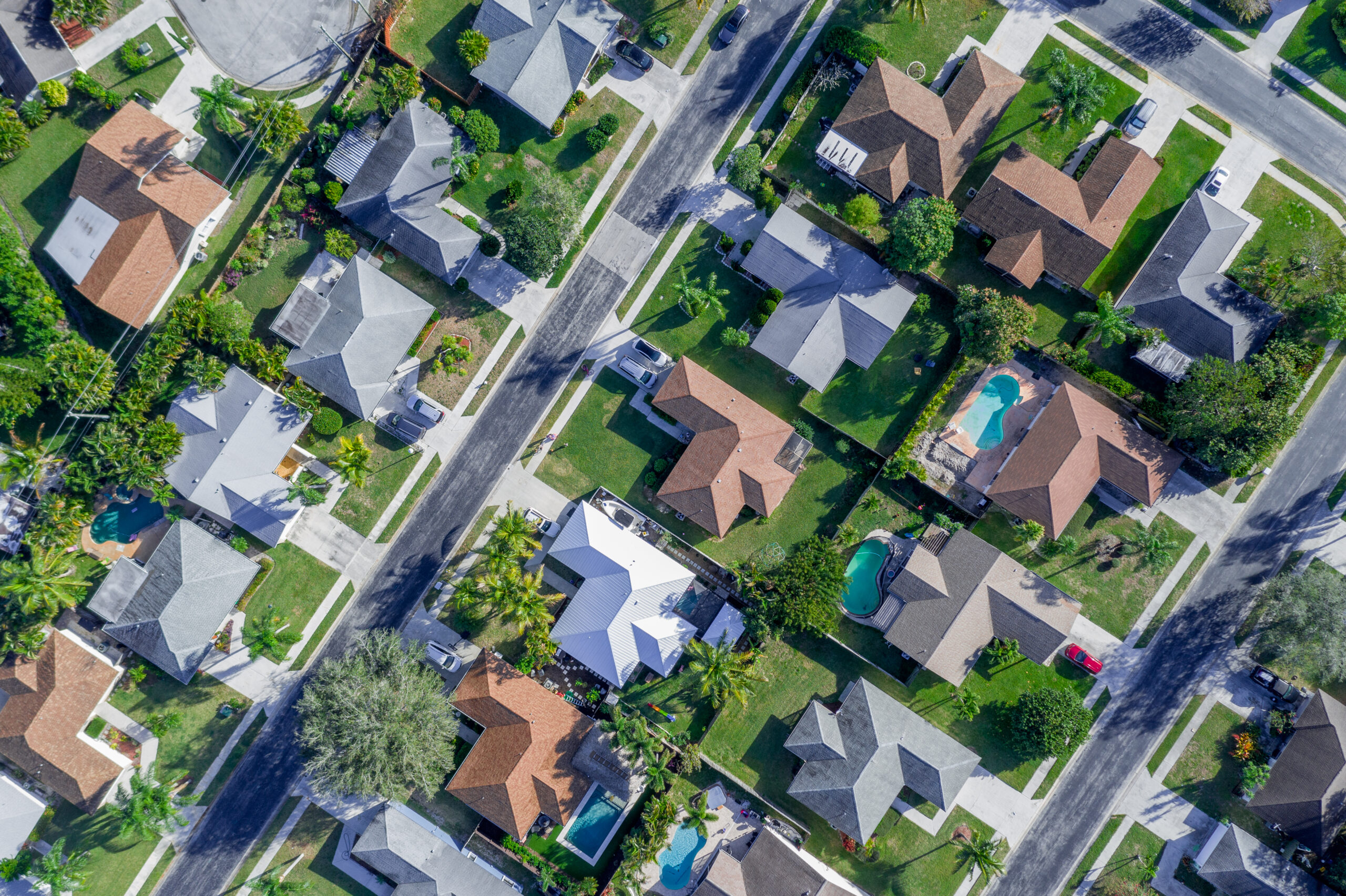 Aerial,Summer,View,Of,Warm,Sunny,Neighborhood,Community,Roofs,With