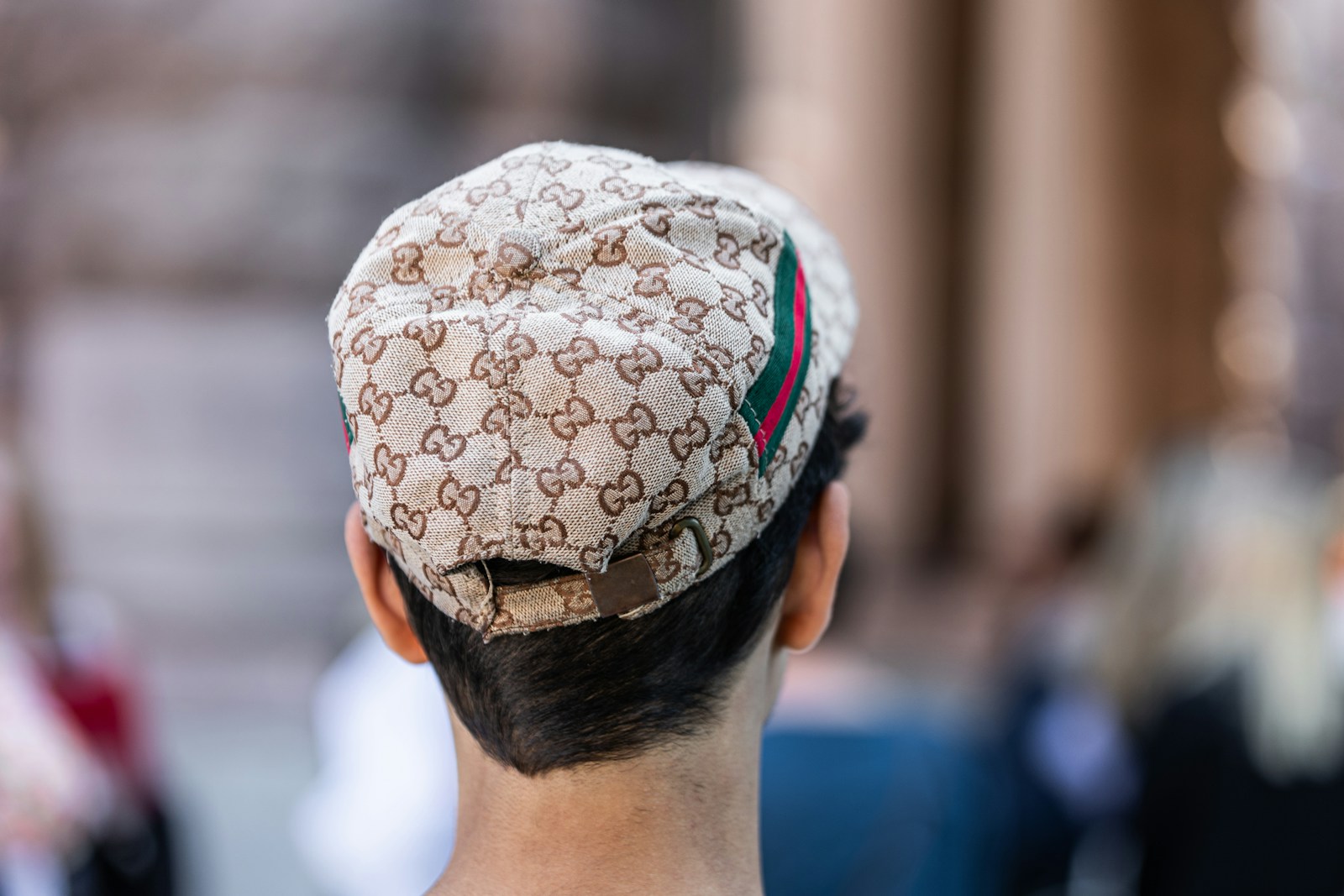 A Swedish youth dons a counterfeit Gucci cap outside the Swedish Parliament building. Swedish Liberal party representative, Martin Melin, made the term 'Guccikepskopia' go viral during a press conference by suggesting that young men wearing counterfeit Gucci caps could be singled out for searches by the police.