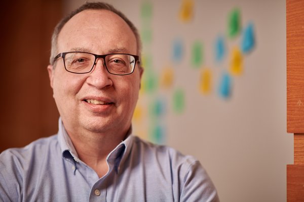 Photo of Dennis with post-it notes behind him