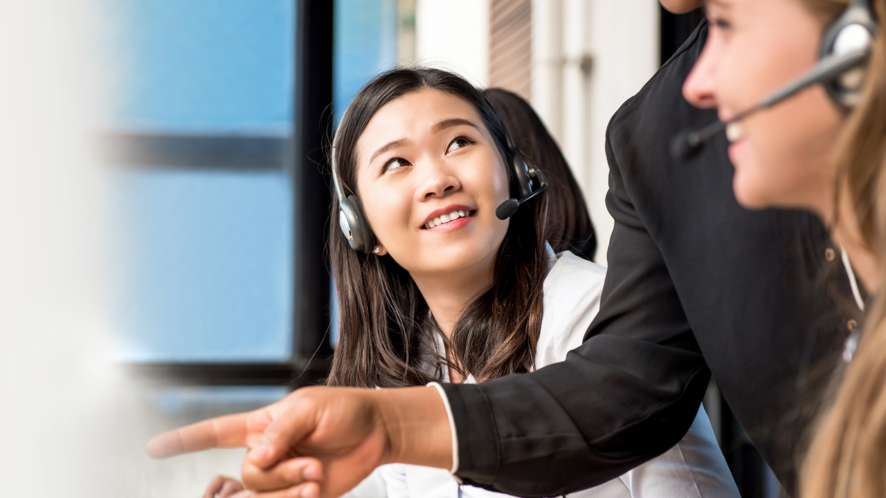 Happy client services team talking to clients