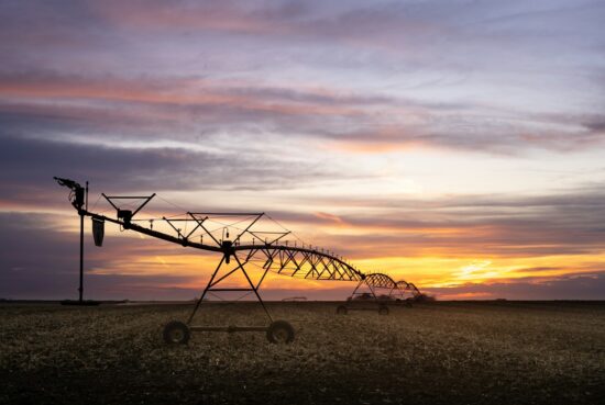 Farm equipment at sunset