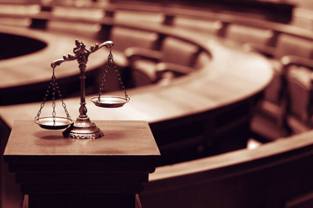Scales of justice in an empty courtroom