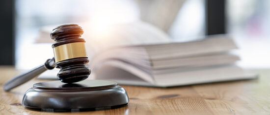 Wooden brown judge gavel on the table, copy space, banner background.
