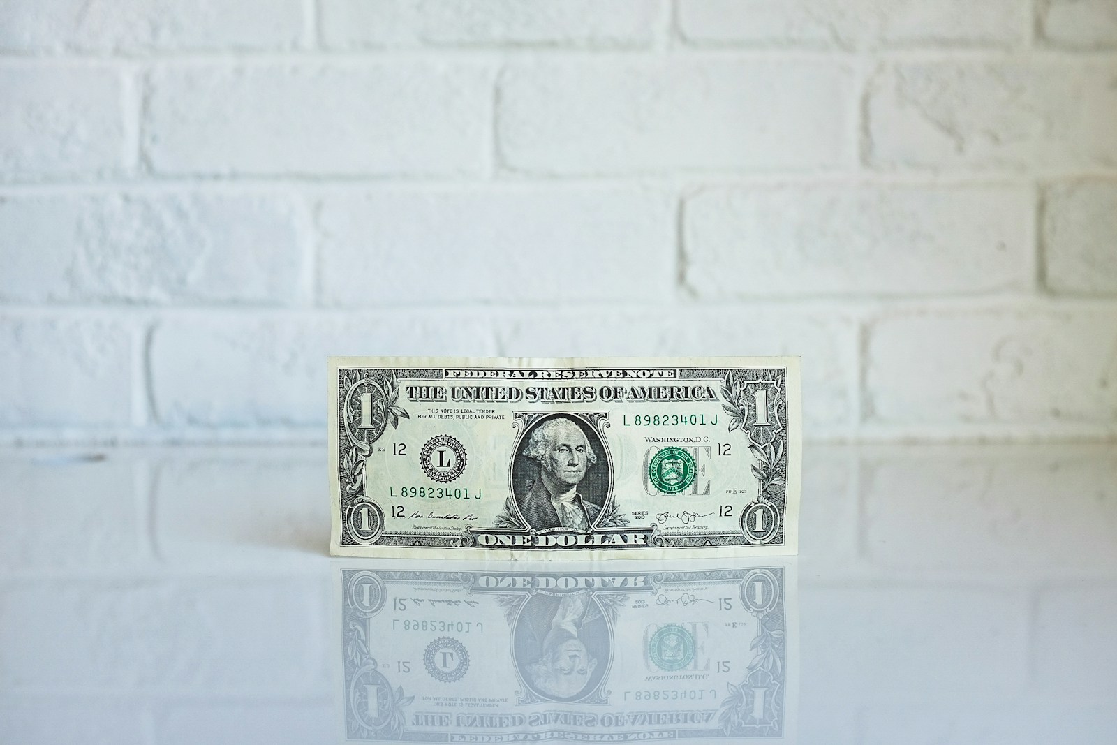 One dollar bill by the wall