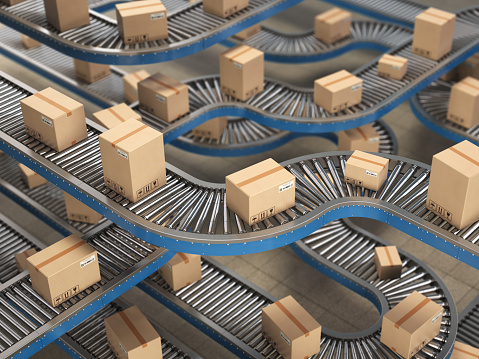 Cardboard boxes on conveyor roller in distribution warehouse, Delivery and packaging service concept background.