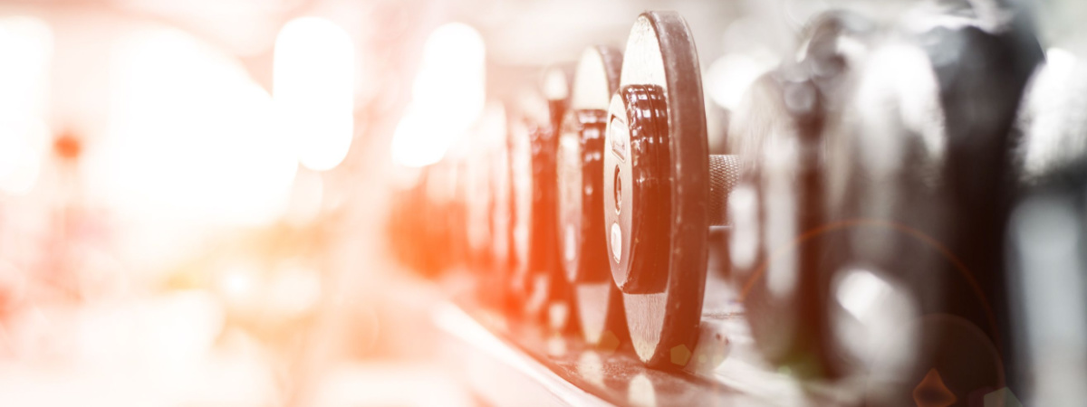 Rows of dumbbells in the gym-transactional fitness-Shutterstock_165038135