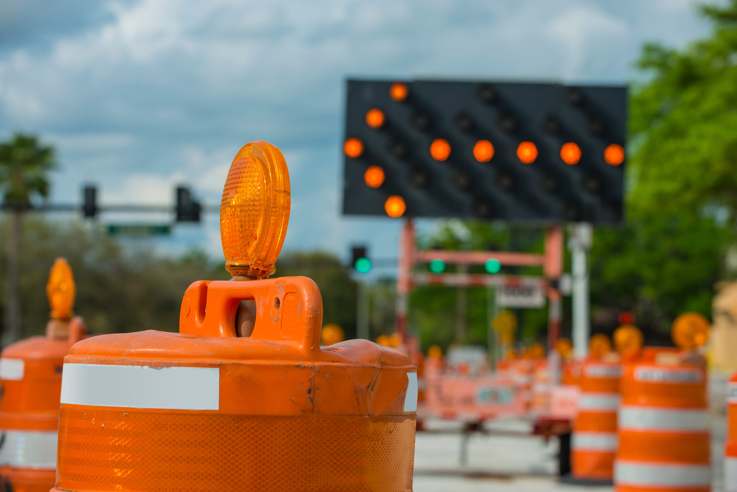 Road closed signs detour traffic temporary street work orange lighted arrow and barrels
