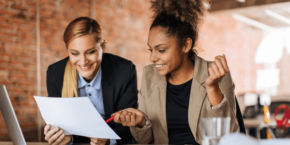 Co-workers reviewing a service of process checklist for legal professionals