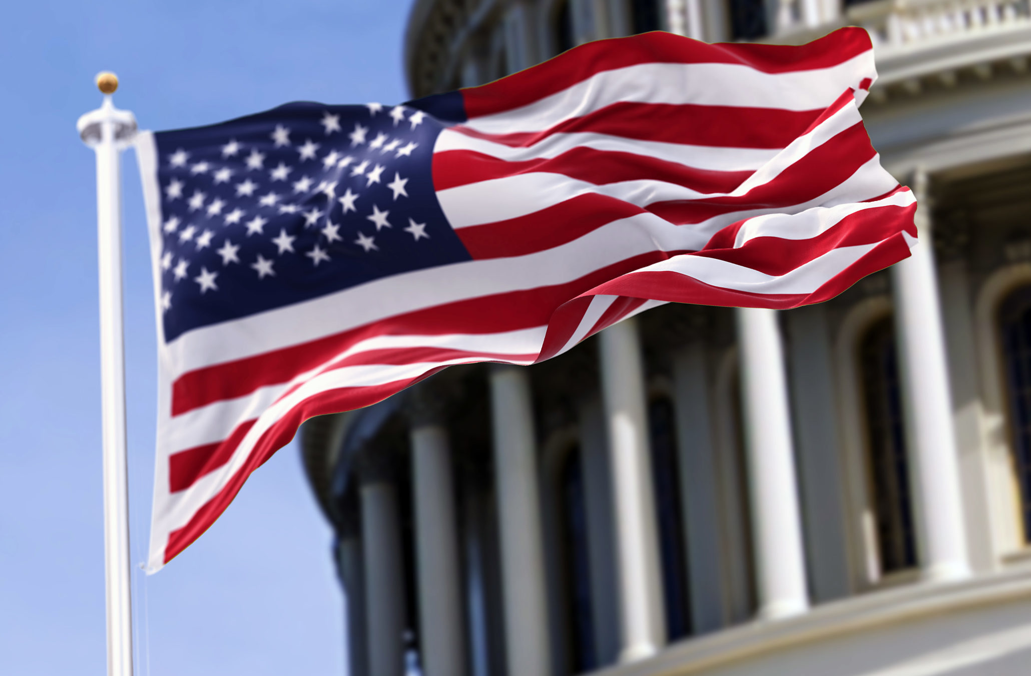 GThe-flag-of-the-united-states-of-america-flying-in-front-of-the-capitol-building-blurred-in-the-background-ettyImages-1314505420
